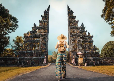 A woman walking toward a candi bentar