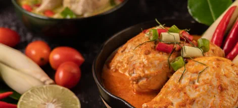 Chicken curry, surrounded by vegetables